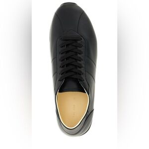 The Row  Sleek Black Sneakers